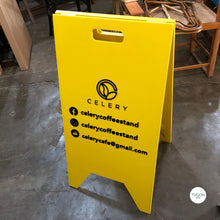 Load image into Gallery viewer, FOLDING STANDEE SIGNAGE is a premium business sign solution for businesses and organizations. Constructed from high-quality wood and acrylic, the sign is designed to be lightweight and movable. Perfect for must-have sign applications, FOLDING STANDEE SIGNAGE offers superior durability and straightforward setup.