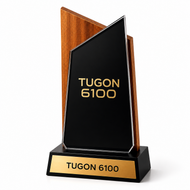 A custom acrylic and wood trophy plaque engraved with 'TUGON 6100' on both the front black panel and the base gold plate, shown on a clean white background.
