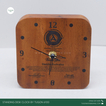 Load image into Gallery viewer, This clock is crafted from high-quality mahogany wood and perfect for adding a personal touch to your workspace. This elegant timepiece isn&#39;t just functional; it&#39;s a statement piece that brings warmth and character to any desk. Personalize it with a name or special message, making it a thoughtful gift for yourself or a loved one. It&#39;s more than just a clock; it&#39;s a daily reminder of the moments that matter. Whether for home or office, let this unique desk clock be your go-to for keeping time stylishly.
